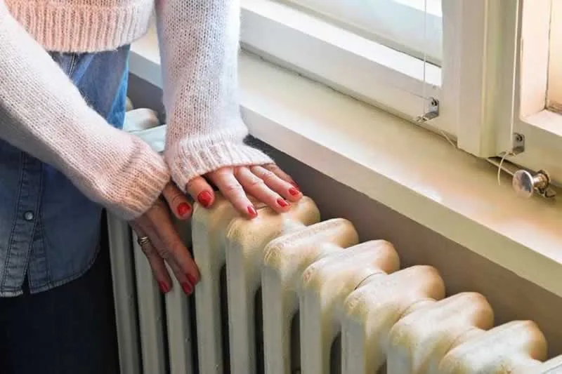women next to the radiator