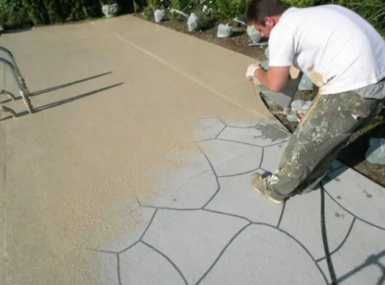 worker pouring new coat of concrete over old concrete