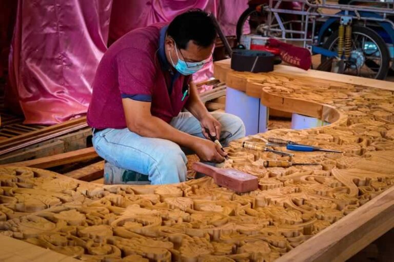 man carving huge project