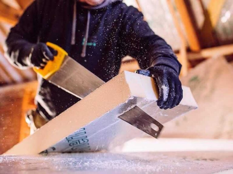 man cutting with saw