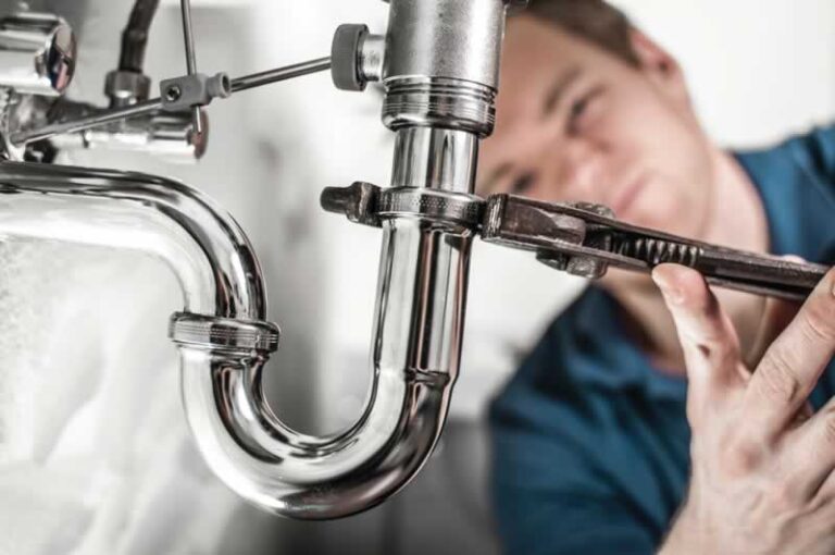 plumber fixing the drain