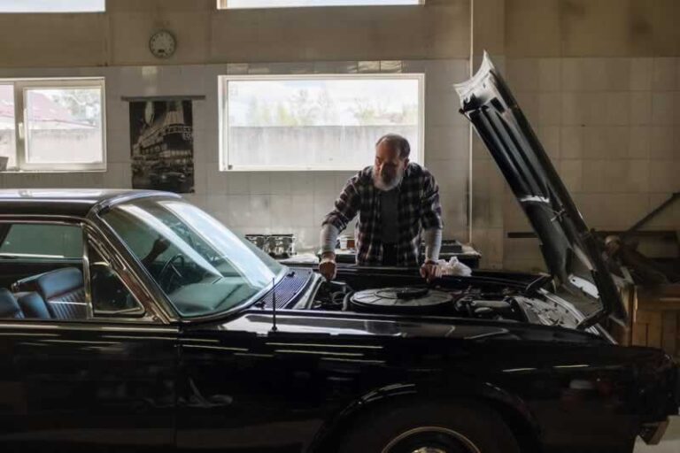 man fixing the car in the garage
