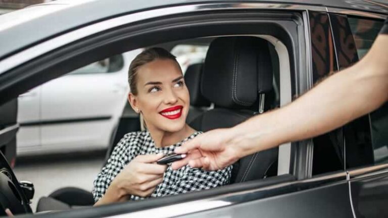 woman receiving car keys