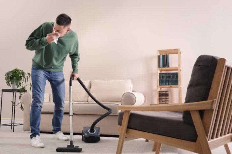 man with allergy vacuuming