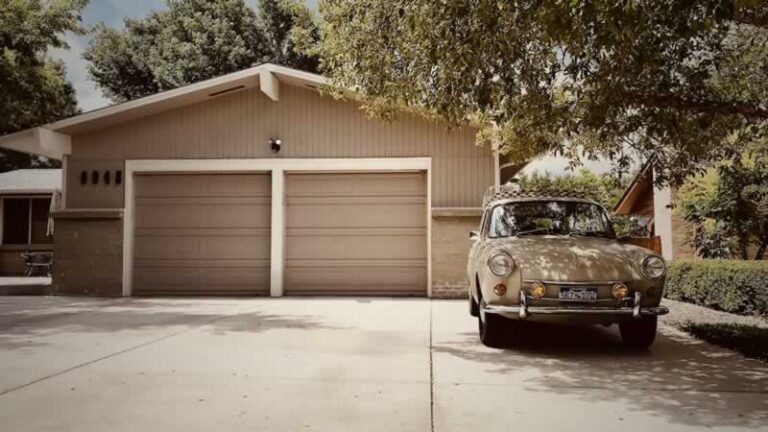 vintage car in front of garage