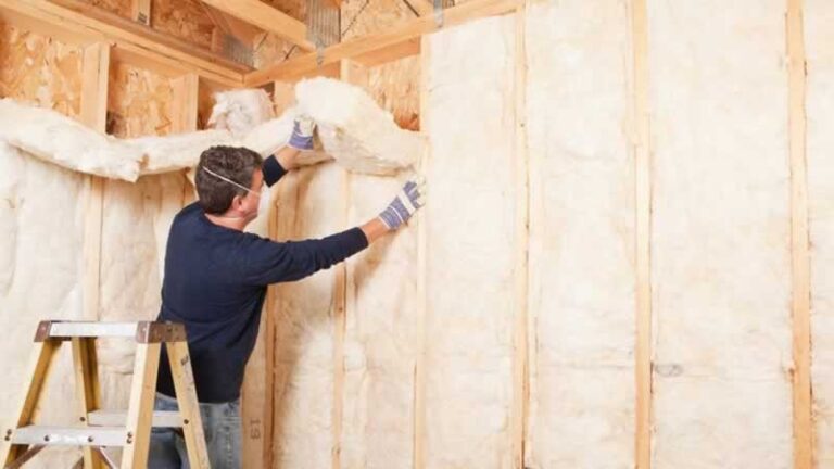 man installing wool insulation