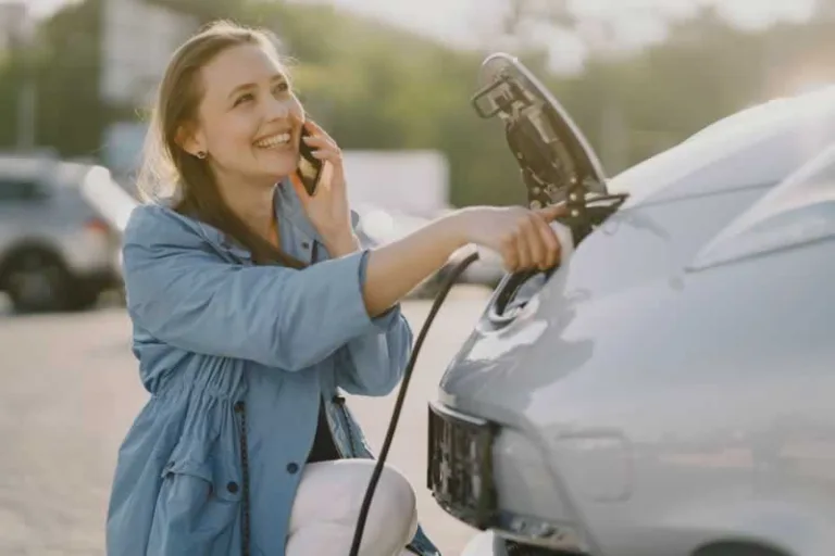 woman charging electric car