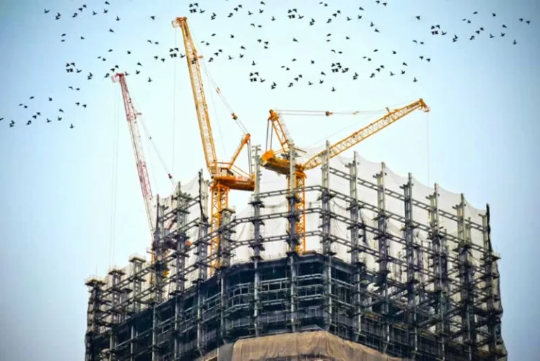 skyscraper construction with cranes on the top