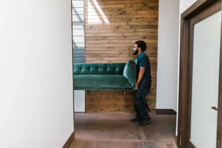 man carrying sofa