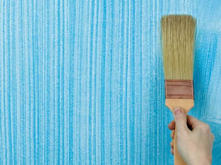 painting wall with brush