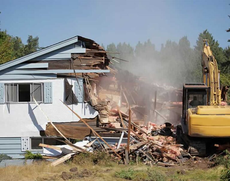 excavator demolishing a house