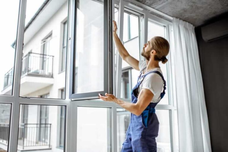worker replacing PVC window