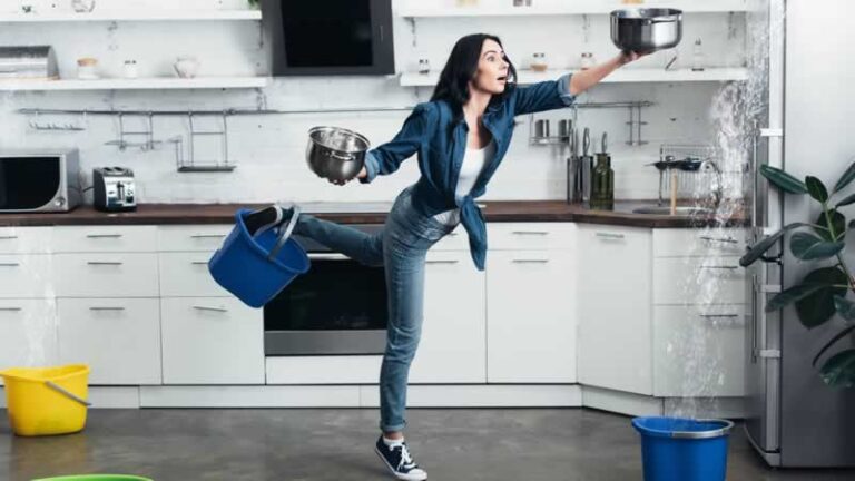 woman collecting water in the kitchen