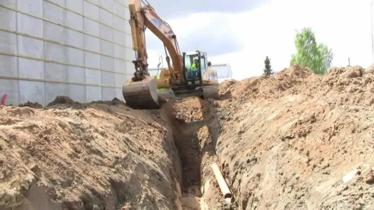 excavator digging trench for sewer