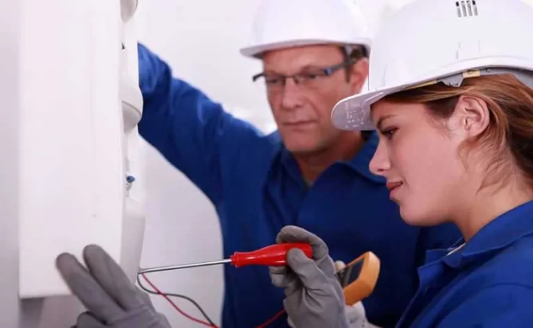 female electrician checking fuse box