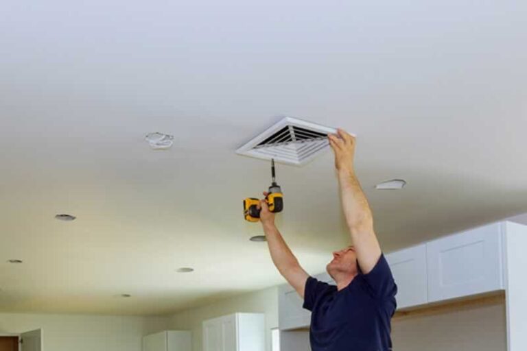 man installing mini split system