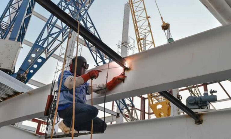 man welding a structural beam