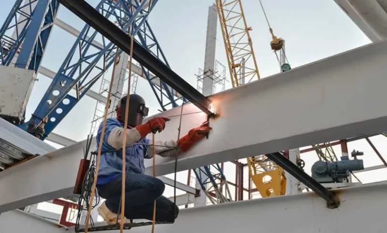 man welding a structural beam