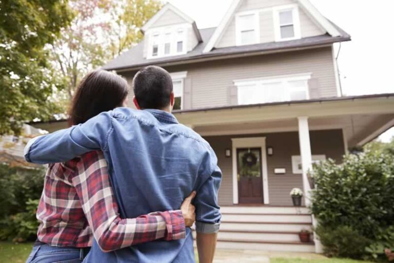 couple in front of a new house