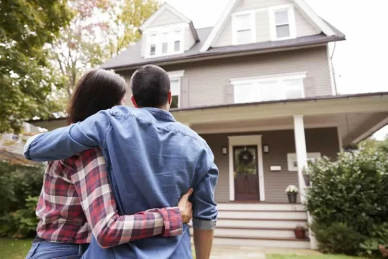 couple in front of a new house