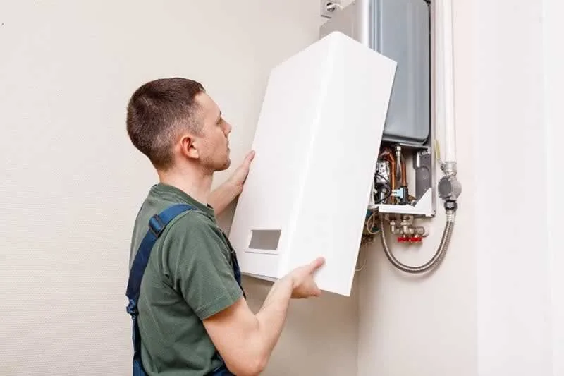 man installing boiler