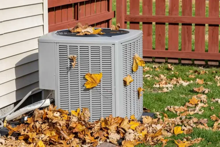 outdoor AC unit covered with leaves