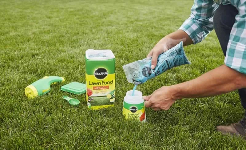 applying grass fertilizer and lawn food