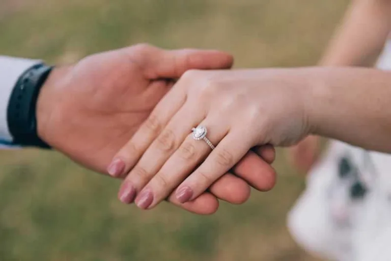 putting the engagement ring on hand