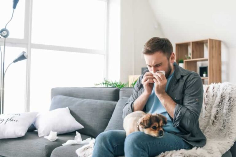 man sneezing because of allergies in upholstery