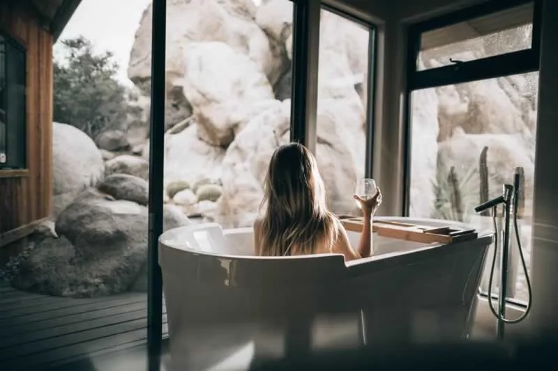 woman in bathroom with biophilic design