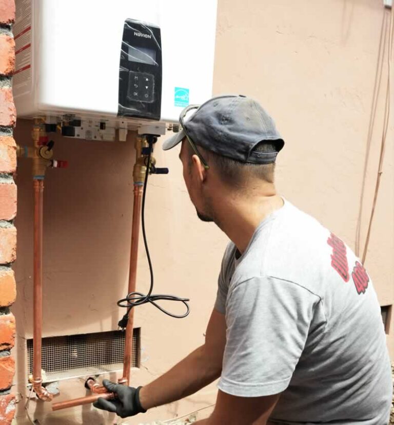 plumber servicing boiler