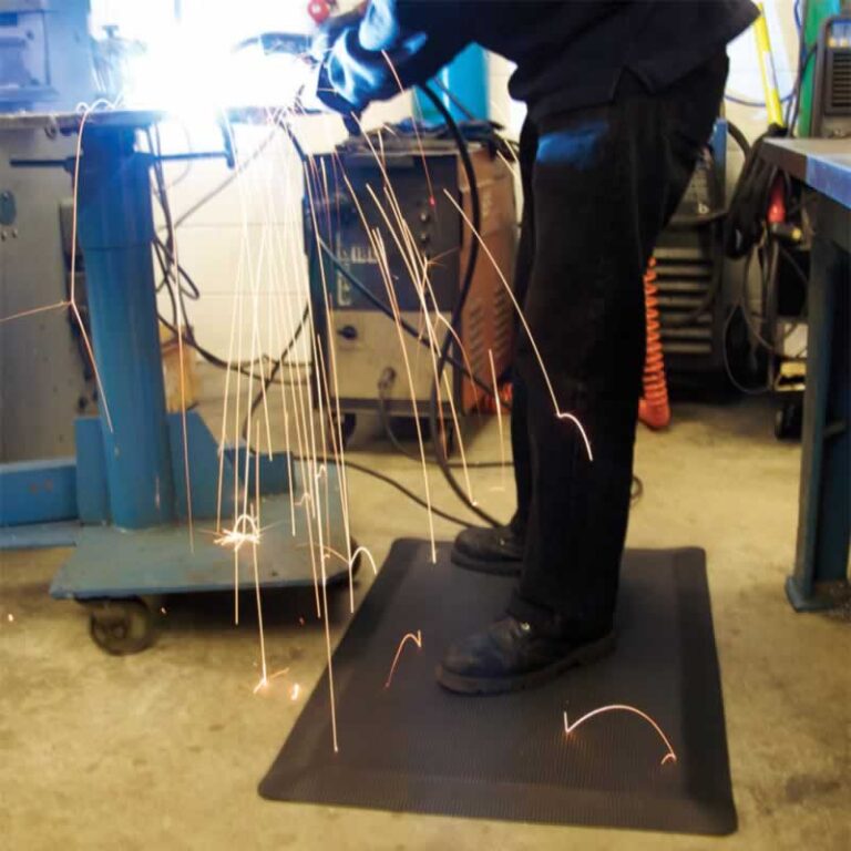 welder welding on a mat