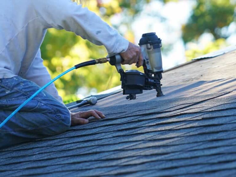 roofer nailing patch on the roof