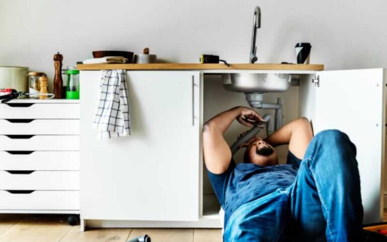 man fixing plumbing issue