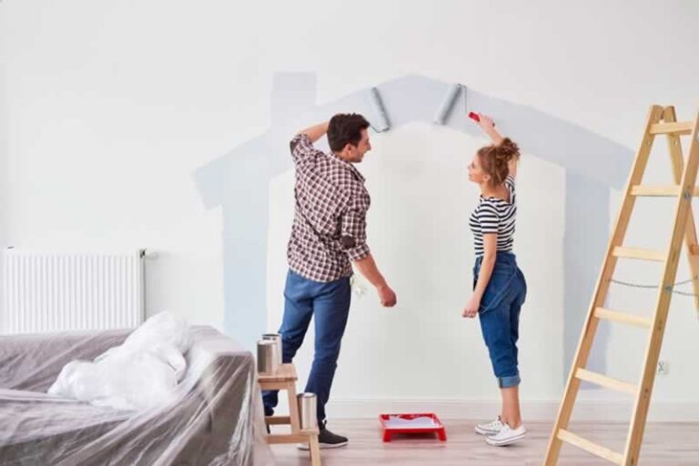 couple painting a wall