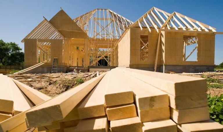 pile of lumber in front of house in construction