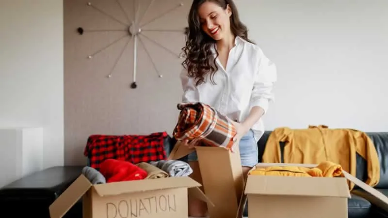 women folding unnecessary clothes