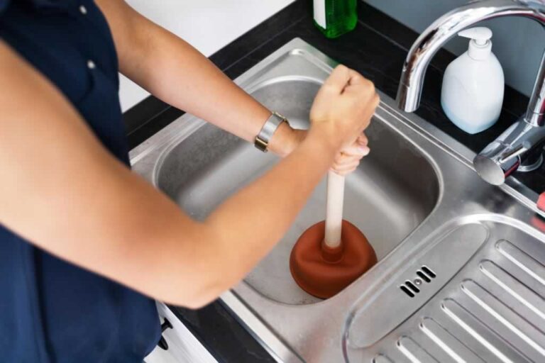 unclogging kitchen sink with plunger