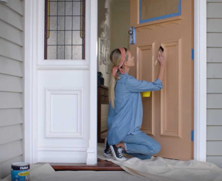 woman painting front door