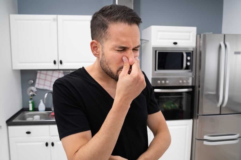 man sensing the smell of leaking gas