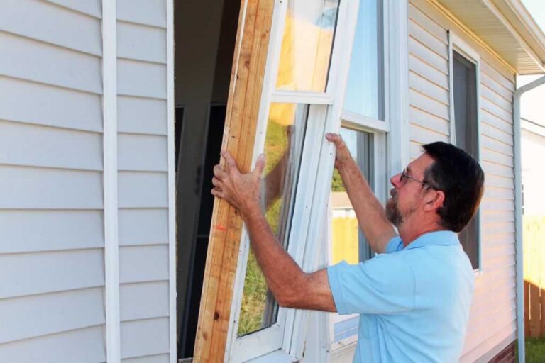 man removing old window