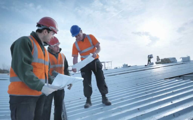 contractors planning a technique for fixing a commercial roof leak