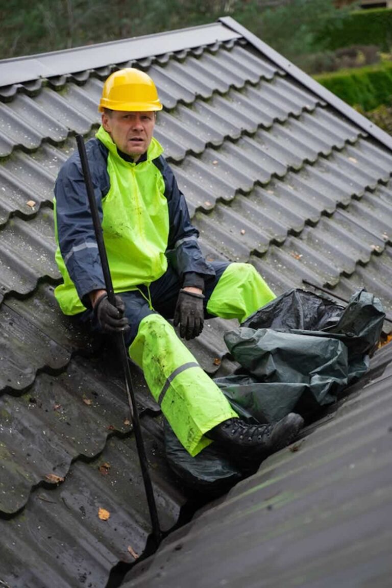 man resting after cleaning the roof