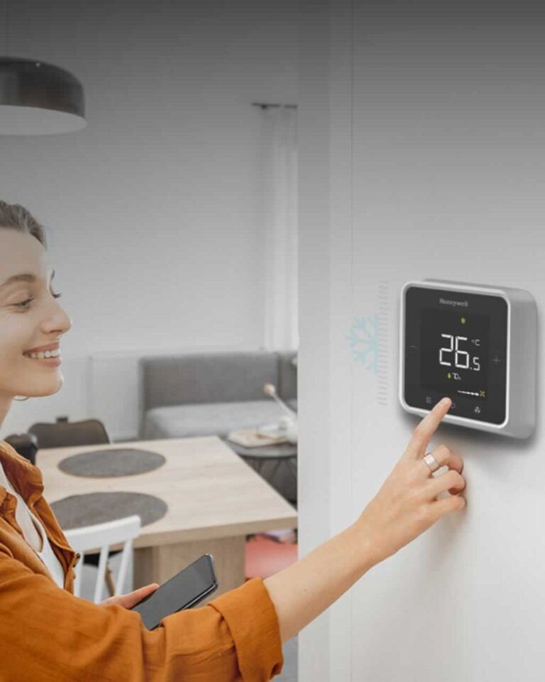 woman setting up smart thermostat