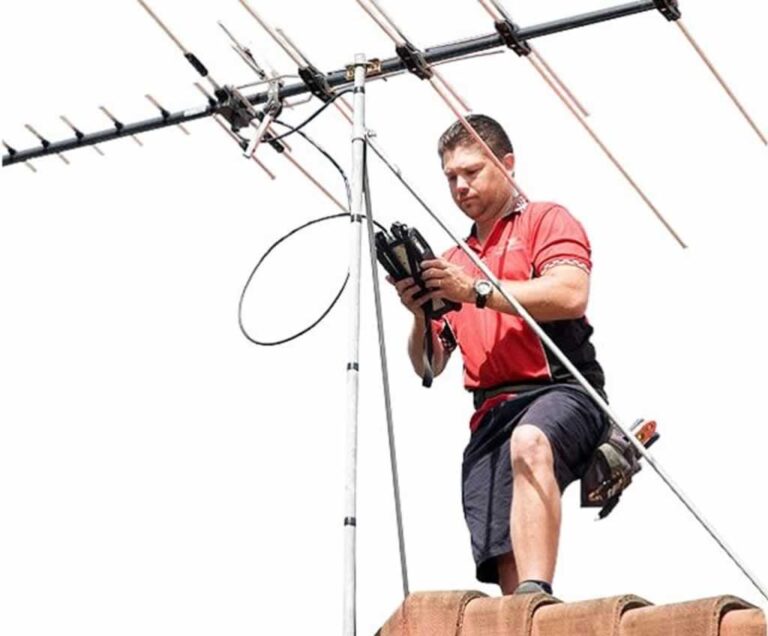 aerial installer calibrating antenna on the roof