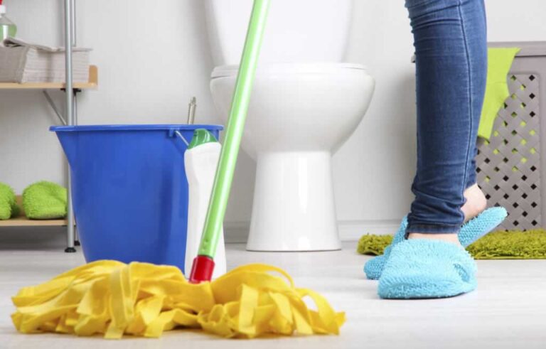 cleaning bathroom floor with a mop