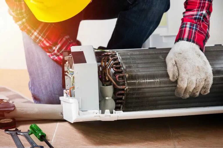 technician repairing broken indoor AC unit