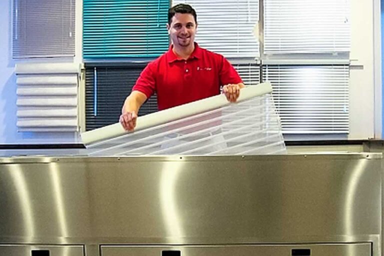 man cleaning window blinds with ultrasonic cleaner