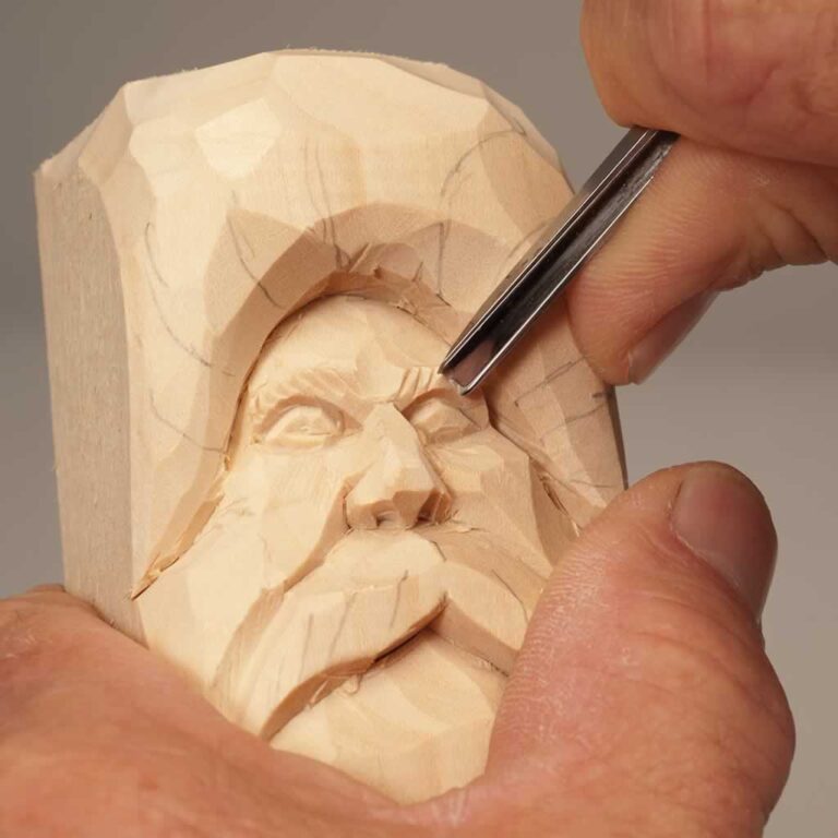 carving a wood spirit face in a block of wood