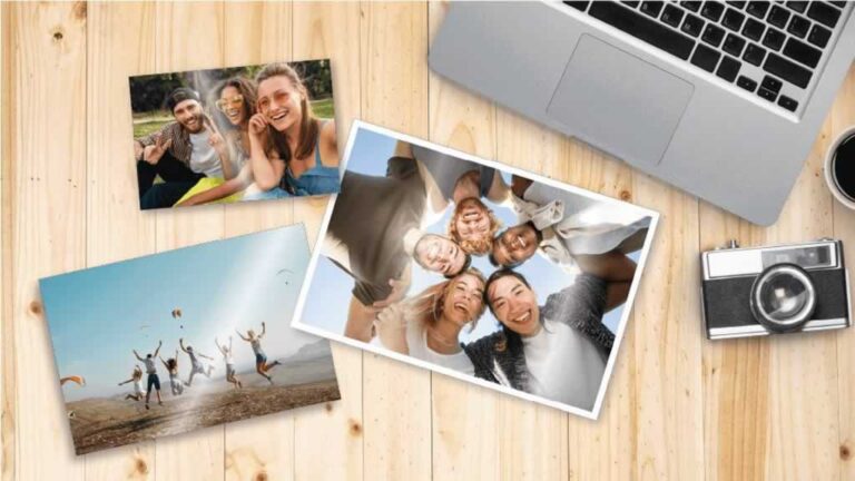 photos on the table with laptop and camera